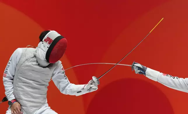 Kyosuke Matsuyama of Japan, left, competes against Kazuki Iimura of Japan during a men's foil individual fencing semi-final at the Asian Games in Nagoya, Japan, Tuesday, Sept. 22, 2026. (AP Photo/Aaron Favila)
