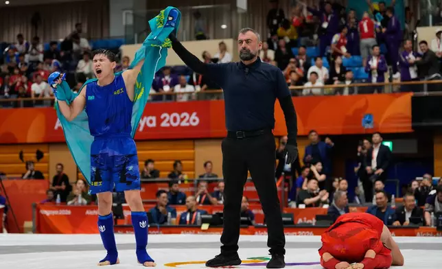 Kadyrbek Shinbayev of Kazakhstan, left, celebrates after winning against Behruz Khurshedzoda of Tajikistan during their men's modern 71kg mixed martial arts final at the Asian Games in Nagoya, Japan, Tuesday, Sept. 22, 2026. (AP Photo/Dita Alangkara)