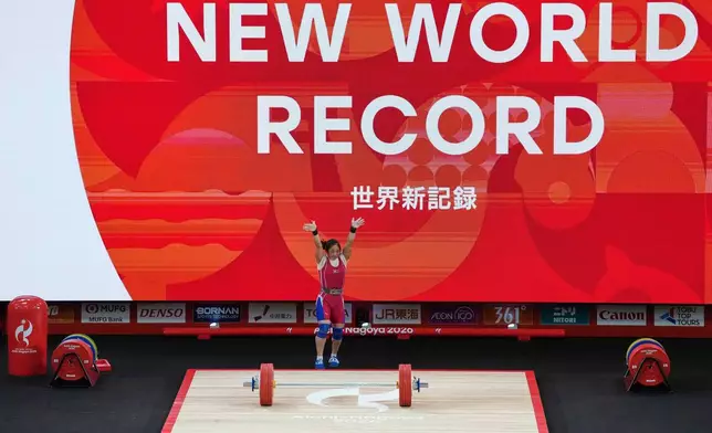 North Korea's Oh Kwang Ok reacts after a successful lift during the women's 57kg weightlifting final at the Asian Games in Nagoya, Japan, Friday, Sept. 25, 2026. (AP Photo/Aaron Favila)
