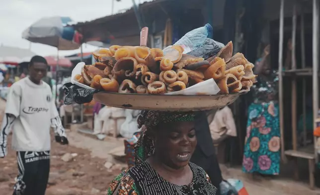 A woman sells cow skin at a market in Ibadan, Nigeria, Wednesday, Sept. 9, 2026. (AP Photo/Sunday Alamba)