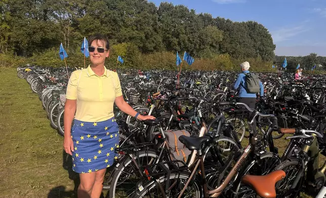 In this photo taken with a smartphone, Janet Metcalfe stands with her bike in the bike park at the Solheim Cup venue, Bernardus Golf in in Den Bosch, Netherlands, Saturday Sept. 12, 2026. (AP Photos/Mike Corder)