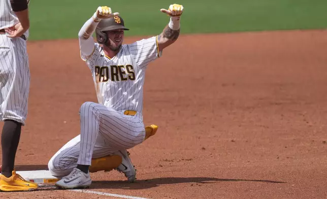 San Diego Padres' Jackson Merrill celebrates his two-RBI triple during the third inning of a baseball game against the Washington Nationals Wednesday, Sept. 9, 2026, in San Diego. (AP Photo/Gregory Bull)