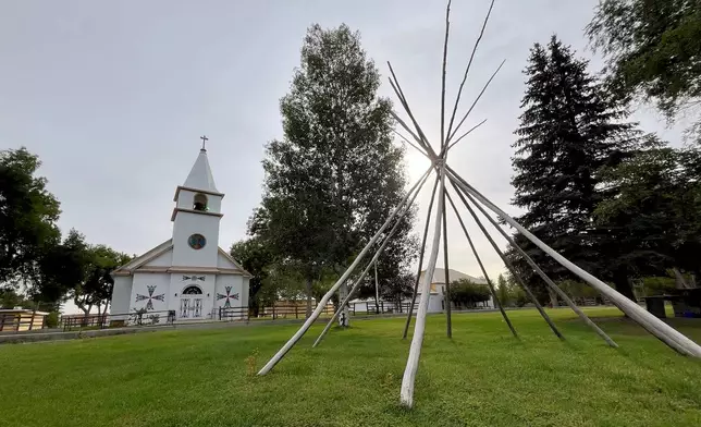 The frame of a teepee is displayed outside the St. Stephens Indian Mission Catholic church in Arapahoe, Wyo., on Monday, Aug. 17, 2026. (AP Photo/Thomas Peipert)