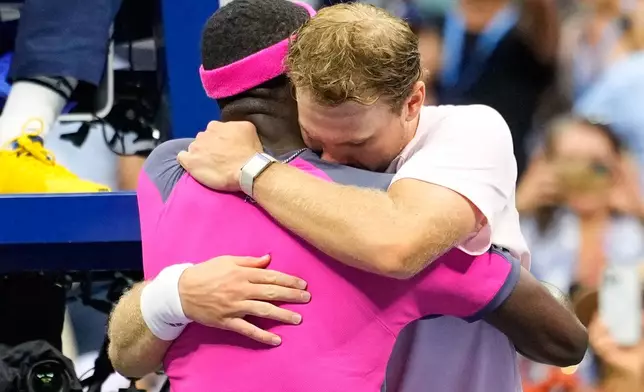 Frances Tiafoe, of the United States, right, and Alex Michelsen, of the United States, embrace after Tiafoe won their match in the quarterfinal round of the U.S. Open tennis championships, Tuesday, Sept. 8, 2026, in New York. (AP Photo/Yuki Iwamura)