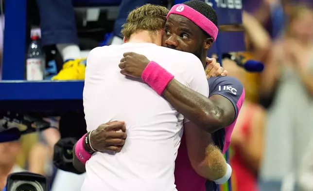 Frances Tiafoe, of the United States, right, and Alex Michelsen, of the United States, embrace after Tiafoe won their match during the quarterfinal round of the U.S. Open tennis championships, Tuesday, Sept. 8, 2026, in New York. (AP Photo/Seth Wenig)