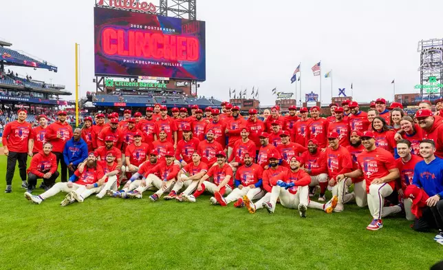 The Philadelphia Phillies pose after they defeated the Tampa Bay Rays, clinching a Wild Card slot in post season baseball play, Sunday, Sept. 27, 2026, in Philadelphia. (AP Photo/Laurence Kesterson)
