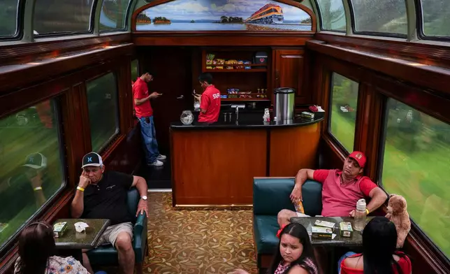 Tourists travel on the Panama Canal Railway train in Gatun, Panama, Saturday, Aug. 29, 2026. (AP Photo/Matias Delacroix)