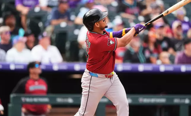 Arizona Diamondbacks' Gabriel Moreno watches his three-run home run off Colorado Rockies starting pitcher Tanner Gordon in the first inning of a baseball game, Thursday, Sept. 24, 2026, in Denver. (AP Photo/David Zalubowski)
