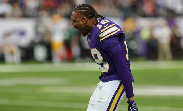 Minnesota Vikings wide receiver Justin Jefferson celebrates a defensive stop against the Green Bay Packers as he watches from the sideline during the second half of an NFL football game, Sunday, Sept. 13, 2026, in Minneapolis, Minn. (AP Photo/Bailey Hillesheim)