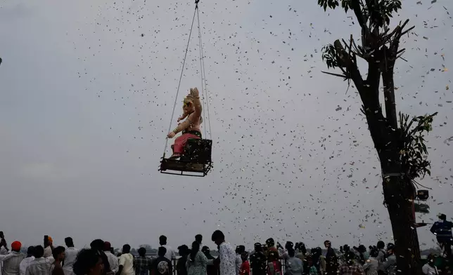 An idol of elephant-headed Hindu god Ganesha is lifted with cranes for immersion in the Hussain Sagar Lake on the final day of Ganesh Chaturthi festival in Hyderabad, India, Friday, Sept. 25, 2026. (AP Photo/Mahesh Kumar A.)