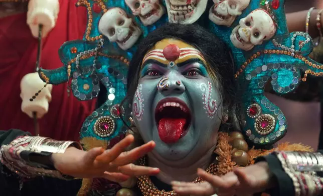 An artist dressed as Hindu goddess Mahakali performs during Ganesh Chaturthi celebrations in Hyderabad, India, Wednesday, Sept. 16, 2026. (AP Photo/Mahesh Kumar A.)