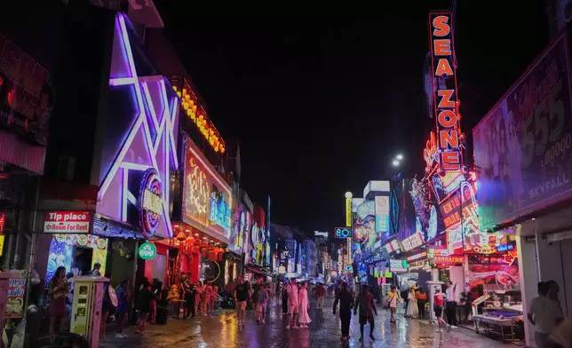 Tourists stroll down Walking Street in Pattaya, Thailand, on Aug. 31, 2026. (AP Photo/Sakchai Lalit)