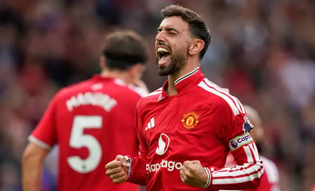 Manchester United's Bruno Fernandes celebrates after scoring his side's third goal during the English Premier League soccer match between Manchester United and Ipswich Town in Manchester, England, Sunday, Aug. 30, 2026. (AP Photo/Dave Thompson)