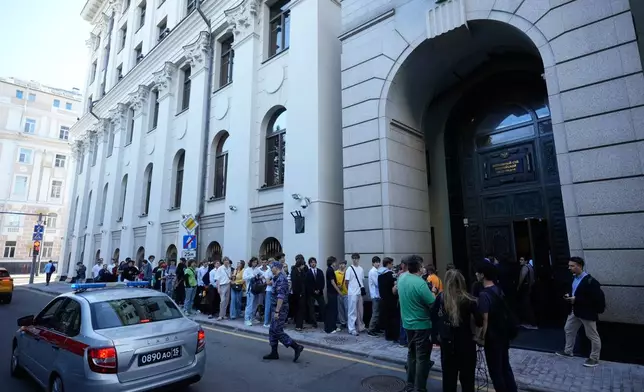 FILE - Supporters of the Yabloko party wait to enter Russia's Supreme Court in Moscow, Monday, Aug. 10, 2026, to attend a hearing on a lawsuit to bar the party from the ballot in the upcoming parliamentary election. (AP Photo/Pavel Bednyakov, File)