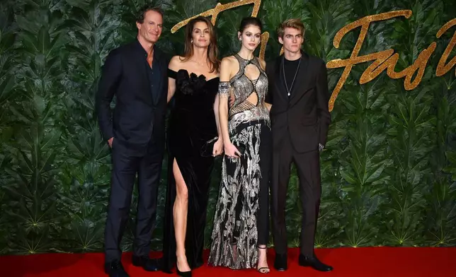 FILE - Businessman Rande Gerber, from left, models Cindy Crawford, Kaia Gerber and Presley Walker Gerber pose in central London, Monday, Dec. 10, 2018. (Photo by Joel C Ryan/Invision/AP, File)