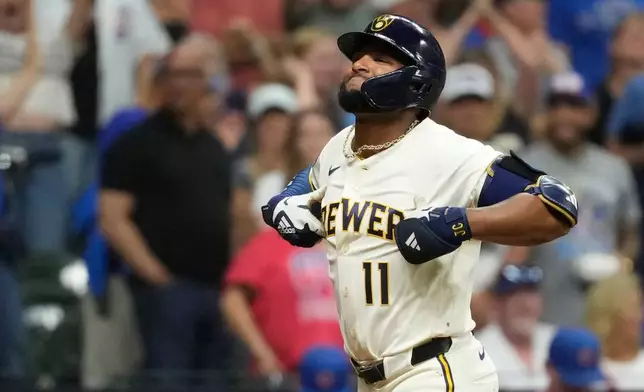Milwaukee Brewers' Jackson Chourio gestures as he rounds the bases after hitting a two-run home during the ninth inning of a baseball game against the Chicago Cubs, Tuesday, Sept. 8, 2026, in Milwaukee. (AP Photo/Aaron Gash)
