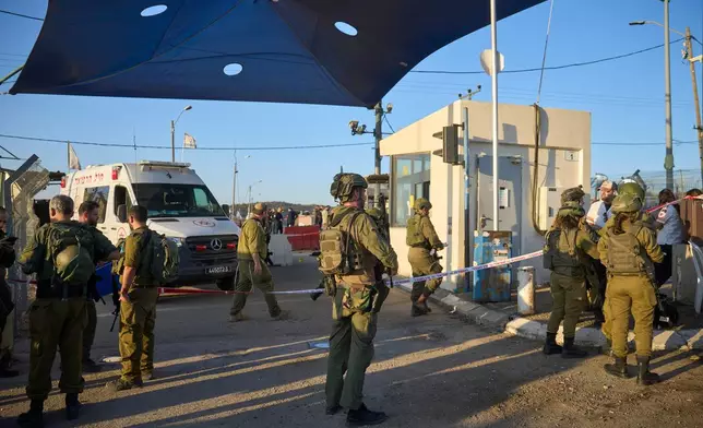 Israeli security forces inspect the scene where, according to police, a Palestinian man was shot and killed after ramming his car into a security checkpoint and seriously wounding an officer, near the West Bank Jewish settlement of Beit Horon, Wednesday, Sept. 23, 2026.(AP Photo/Ohad Zwigenberg)