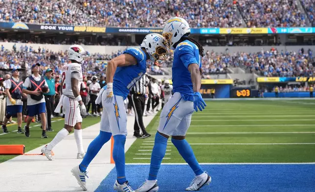 Los Angeles Chargers wide receiver Ladd McConkey (15) is congratulated by wide receiver Quentin Johnston (1) after scoring against the Arizona Cardinals during the second half of an NFL football game, Sunday, Sept. 13, 2026, in Inglewood, Calif. (AP Photo/Gregory Bull)