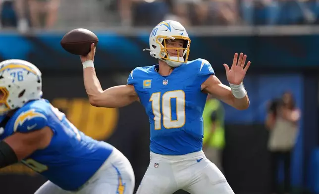 Los Angeles Chargers quarterback Justin Herbert throws a pass during the second half of an NFL football game against the Arizona Cardinals Sunday, Sept. 13, 2026, in Inglewood, Calif. (AP Photo/Gregory Bull)