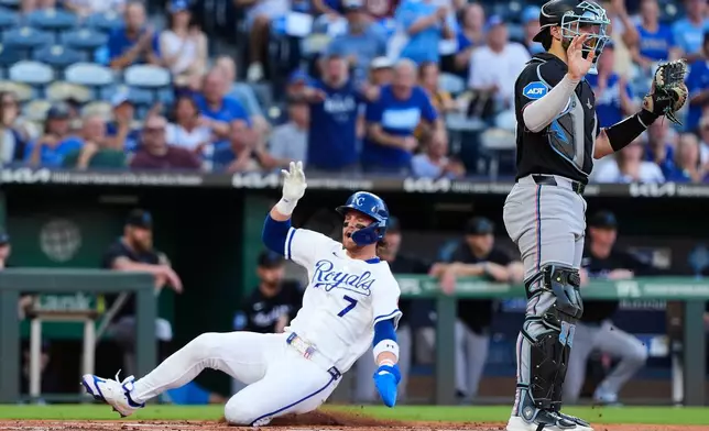 Kansas City Royals' Bobby Witt Jr. (7) slides home to score on a double by Jac Caglianone during the first inning of a baseball game against the Miami Marlins, Wednesday, Sept. 2, 2026, in Kansas City, Mo. (AP Photo/Charlie Riedel)