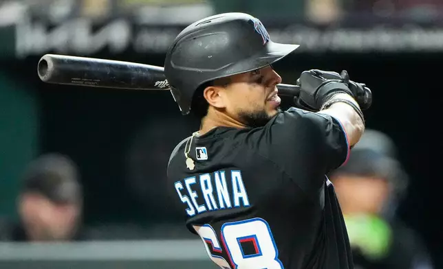 Miami Marlins' Jared Serna watches his sacrifice fly to score one run during the sixth inning of a baseball game against the Kansas City Royals, Wednesday, Sept. 2, 2026, in Kansas City, Mo. (AP Photo/Charlie Riedel)