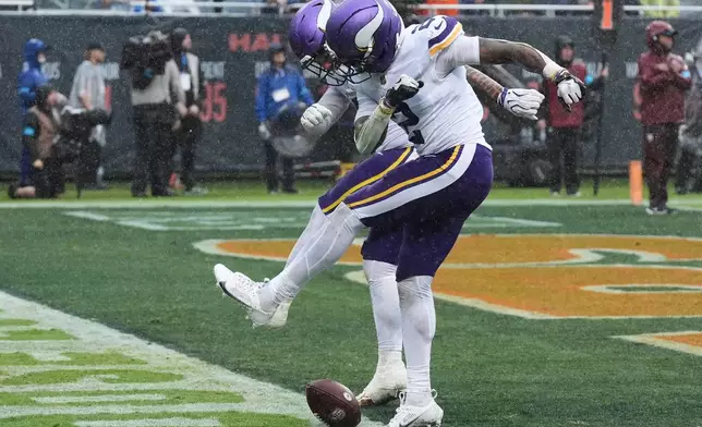 Minnesota Vikings cornerback Isaiah Rodgers, right, celebrates after recovering a fumble by the Chicago Bears during the second half of an NFL football game in Chicago, Sunday, Sept. 20, 2026. (AP Photo/David Banks)