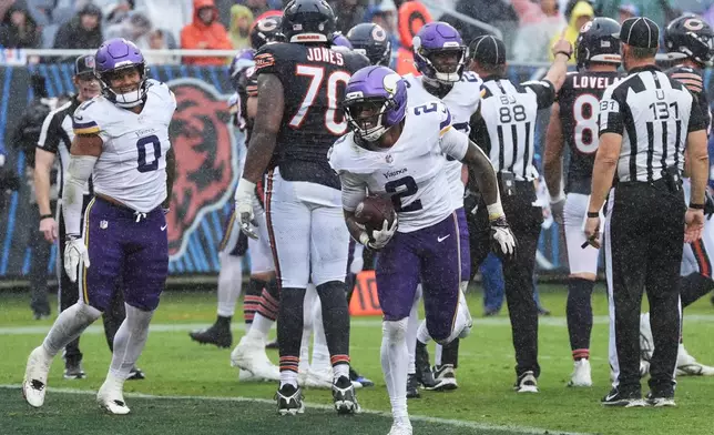 Minnesota Vikings cornerback Isaiah Rodgers (2) celebrates after recovering a fumble during the second half of an NFL football game against the Chicago Bears in Chicago, Sunday, Sept. 20, 2026. (AP Photo/David Banks)
