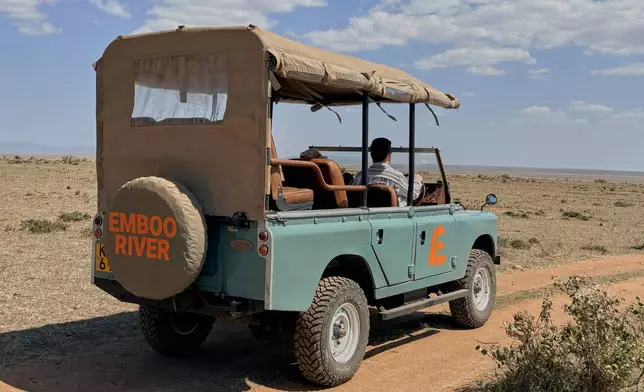 In this photo taken with a smartphone, an electric safari van operated by Emboo Camp drives through the Maasai Mara, Kenya, Saturday, Aug. 29, 2026. (AP Photo/Allan Olingo)