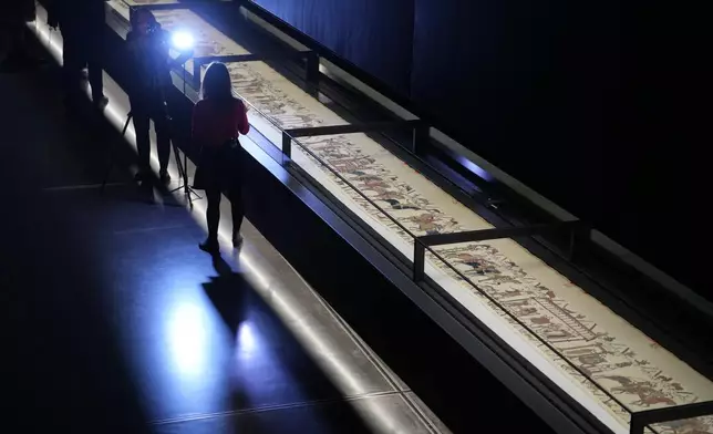 The 70-meter-long Bayeux Tapestry is displayed during a press preview at the British Museum in London after returning to England, following a historic agreement between the UK and France, Monday, Sept. 7, 2026. (AP Photo/Kin Cheung)