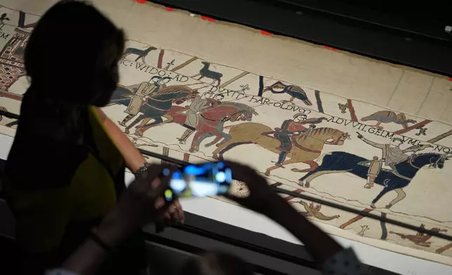 The 70-meter-long Bayeux Tapestry is displayed during a press preview at the British Museum in London after returning to England, following a historic agreement between the UK and France, Monday, Sept. 7, 2026. (AP Photo/Kin Cheung)