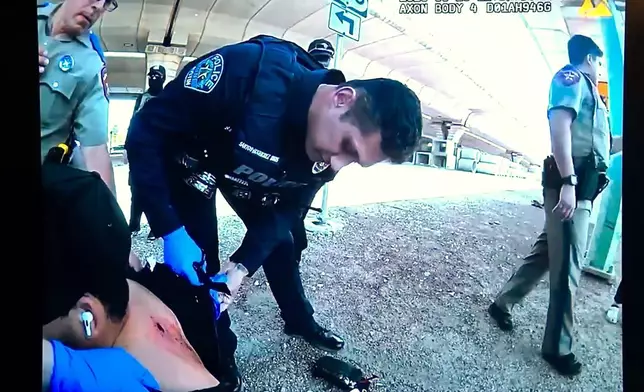 In this image taken from an Austin Police Department officer's body camera video shown at a news conference on Tuesday, Sept. 22, 2026, officers inspect Wilber Rafael Garces Perez's wound after he was shot by a U.S. Immigration and Customs Enforcement agent Sunday, Sept. 20 in Austin. (Austin Police Department via AP)