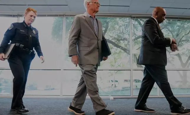 Austin Police Chief Lisa Davis, left, Mayor Kirk Watson, center, and City Manager T.C. Broadnax leave a news conference at the Austin Public Safety Headquarters, Tuesday, Sept. 22, 2026, providing an update after an ICE agent shot and wounded Wilber Rafael Garcés Pérez in Austin, Texas, Sunday. (Sara Diggins/The San Antonio Express-News via AP)