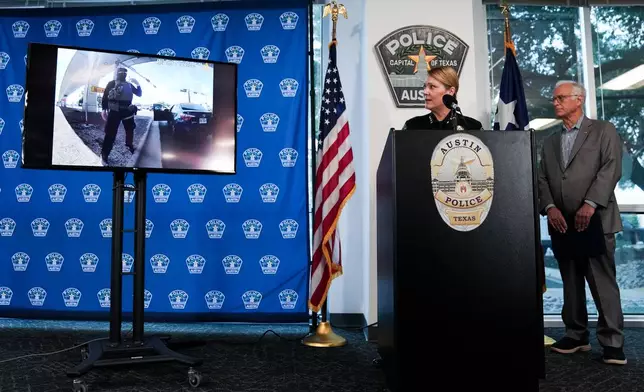 Austin Police Chief Lisa Davis, left, and Mayor Kirk Watson watch as footage from a body-worn camera is played during a news conference at the Austin Public Safety Headquarters, Tuesday, Sept. 22, 2026, providing an update after an ICE agent shot and wounded Wilber Rafael Garcés Pérez in Austin, Texas, Sunday. (Sara Diggins/The San Antonio Express-News via AP)