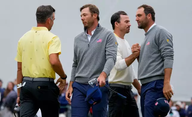 USA teams' Scottie Scheffler, right, and Sam Burns greet International teams' Corey Conners, of Canada, left, and Nick Taylor, of Canada, after their Presidents Cup golf tournament second round foursomes match at Medinah Country Club, Friday, Sept. 25, 2026, in Medinah, Ill. (AP Photo/Chris Carlson)