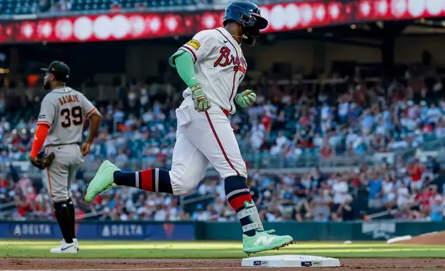Atlanta Braves' Michael Harris II, right, rounds the bases after hitting a solo home run against the San Francisco Giants during the second inning of a baseball game, Monday, Aug. 31, 2026, in Atlanta. (AP Photo/Erik S. Lesser)