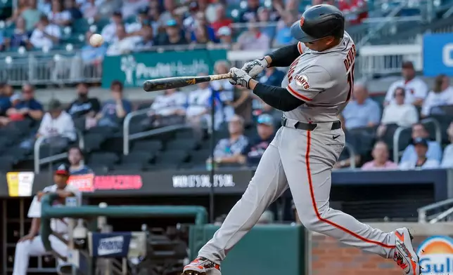 San Francisco Giants designated hitter Rafael Devers hits a solo home run against the Atlanta Braves during the first inning of a baseball game, Monday, Aug. 31, 2026, in Atlanta. (AP Photo/Erik S. Lesser)