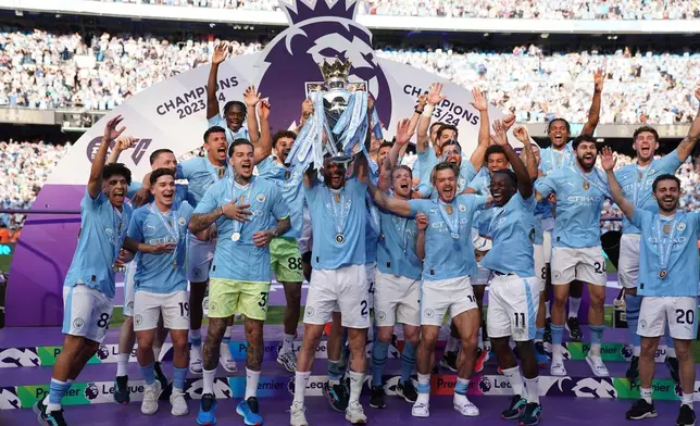 FILE - Manchester City players celebrate with the Premier League trophy after the English Premier League soccer match between Manchester City and West Ham United in Manchester, England, Sunday, May 19, 2024. (AP Photo/Dave Thompson, File)