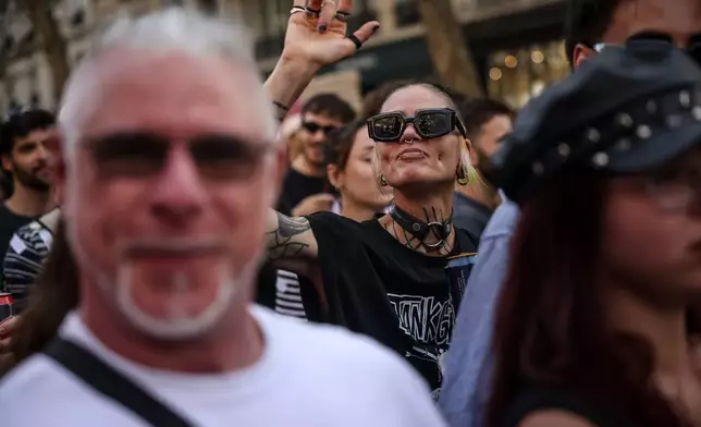 Partygoers dance during the Techno Parade in the streets of Paris, Saturday, Sept. 19, 2026. (AP Photo/Thomas Padilla)