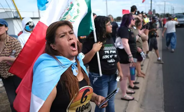 People protest where local authorities say a U.S. Immigration and Customs Enforcement officer (ICE) shot and wounded a man in Austin, Texas, Sunday, Sept. 20, 2026. (AP Photo/Joel Angel Juarez)