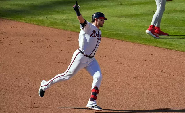 Atlanta Braves' Austin Riley celebrates hitting a three-run home run in the eighth inning against the Philadelphia Phillies during Game 1 of baseball's National League Wild Card Series, Tuesday, Sept. 29, 2026, in Atlanta. (AP Photo/Mike Stewart)