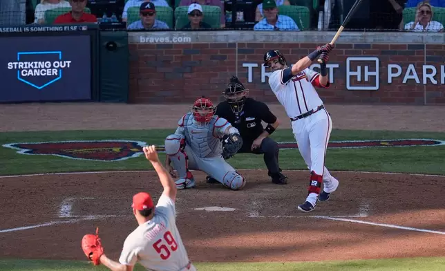 Atlanta Braves' Austin Riley hits a three-run home run off Philadelphia Phillies pitcher Jhoan Duran (59) in the eighth inning during Game 1 of baseball's National League Wild Card Series Tuesday, Sept. 29, 2026, in Atlanta. (AP Photo/Mike Stewart)