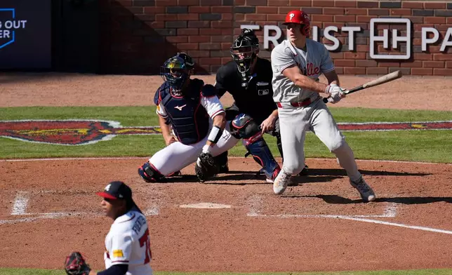 Philadelphia Phillies' J.T. Realmuto hits a two-run triple off Atlanta Braves pitcher Didier Fuentes (72) in the seventh inning during Game 1 of baseball's National League Wild Card Series Tuesday, Sept. 29, 2026, in Atlanta. (AP Photo/Mike Stewart)