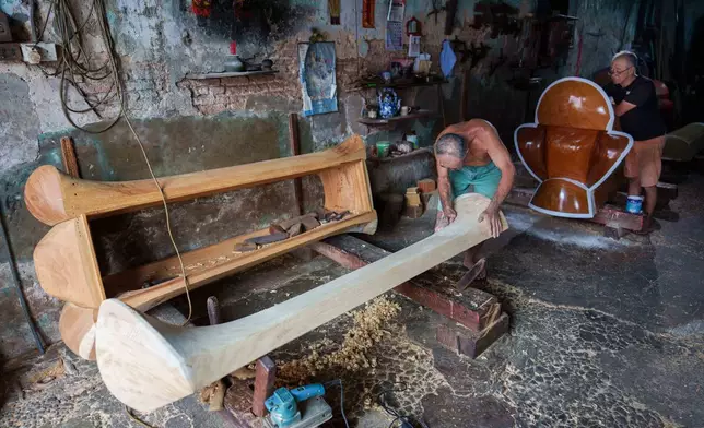 Traditional Chinese coffin maker Goh Khuay Par, left, carves a Mei Hua coffin as his brother Goh Khuay Hou paints another at their workshop in Muar, Johor state, Malaysia, Thursday, Sept. 3, 2026. (AP Photo/Vincent Thian)