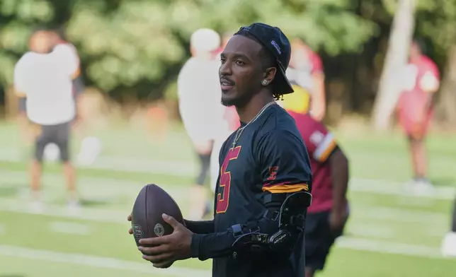 Washington Commanders quarterback Jayden Daniels (5) takes part in NFL football practice in London, Wednesday, Sept. 30, 2026, (AP Photo/Alastair Grant)