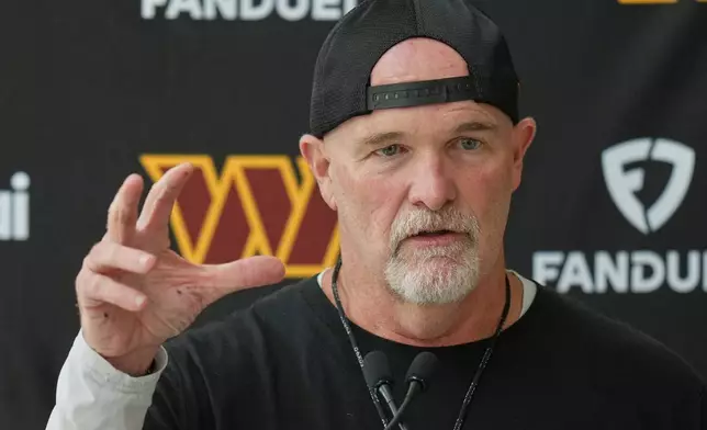 Commanders head coach Dan Quinn speaks to the media before NFL football practice in London, Wednesday, Sept. 30, 2026, (AP Photo/Alastair Grant)
