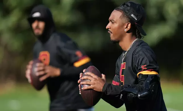 Washington Commanders quarterback Jayden Daniels (5), prepares to throw during a NFL Football practice session in London, Wednesday, Sept. 30, 2026. (AP Photo/Alastair Grant)