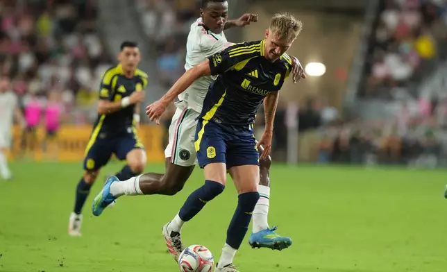 Inter Miami defender Fricio Caicedo (15) defends Nashville forward Sam Surridge (9) during the first half of an MLS soccer match, Saturday, Sept. 12, 2026, in Miami. (AP Photo/Marta Lavandier)