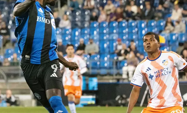 CF Montreal's Prince Owusu (9) heads the ball as FC Cincinnati's Bryan Ramirez (29) looks on during the first half of an MLS soccer game in Montreal on Saturday, Sept. 26, 2026. (Peter McCabe/The Canadian Press via AP)