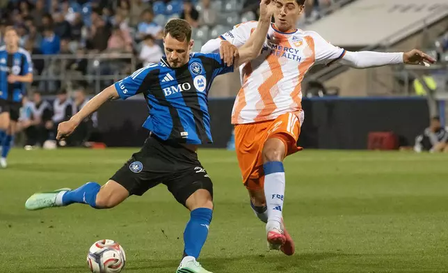 FC Cincinnati's Gerardo Valenzuela, right, attempts to steal the ball from CF Montreal's Fabian Herbers (21) during the first half of an MLS soccer game in Montreal on Saturday, Sept. 26, 2026. (Peter McCabe/The Canadian Press via AP)