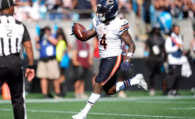 Chicago Bears running back D'Andre Swift (4) runs to score a touchdown during the second half of an NFL football game, Sunday, Sept. 13, 2026, in Charlotte, N.C. (AP Photo/Erik Verduzco)